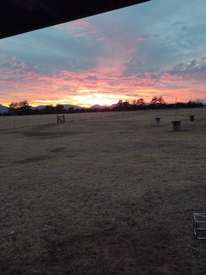 Escape to a serene rural landscape surrounded by rolling hills and open fields.