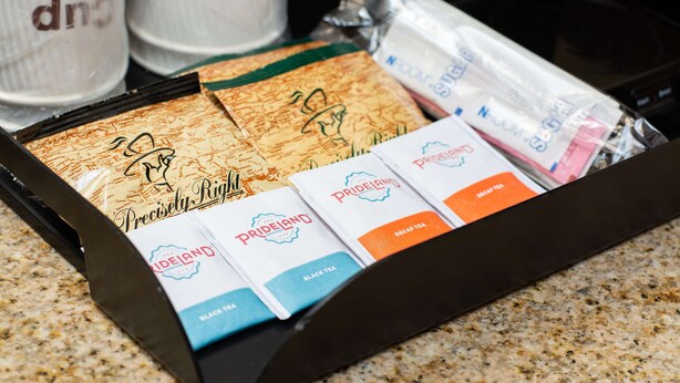 A box of PrideLand tea bags with various flavors like black tea and decaf tea. - Portland Inn & Suites (Portland)