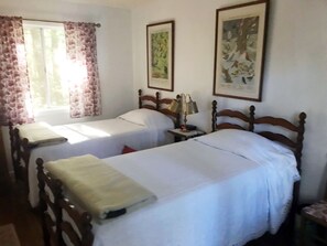 West bedroom in guest cabin, looking south at trees up to 90-feet tall;