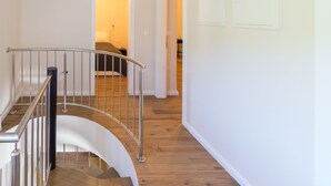 A modern staircase with a metal railing leading to a bedroom with a bed and a nightstand. - Villa Lali - Modern Villa near the sea in Lukoran (Lukoran)