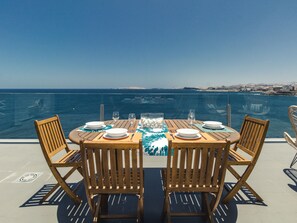 A table set for two with a view of the sea.