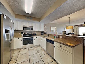 Enjoy cooking in this fully equipped kitchen with a refrigerator, microwave, oven, and dishwasher.