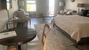 A well-lit room with a bed, a desk, and a dining area. - Coupeville Coveland Suite #3 (Coupeville)