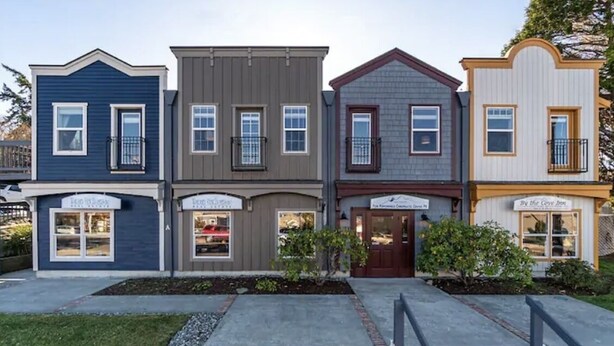 A row of townhouses with commercial spaces on the ground floor, including a restaurant and a shop. - Coupeville Coveland Suite #3 (Coupeville)