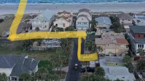 An aerial view of a coastal residential area with houses, a beach, and a clear sky. - Beautifully remodeled home steps away from the Beach! (Jacksonville Beach)