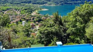 A swimming pool with a view of a lake and mountains. - Casa Pina by Interhome (Porlezza)