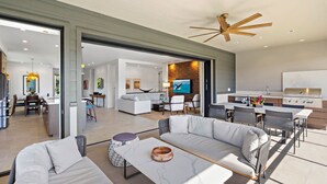 A modern open-plan living space with a kitchen, dining area, and seating area.