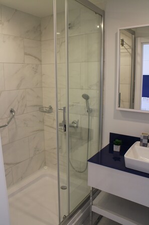 Shower, hair dryer, towels, soap