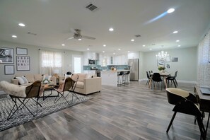 Relax in this inviting living space with a sofa, coffee table, and dining area.