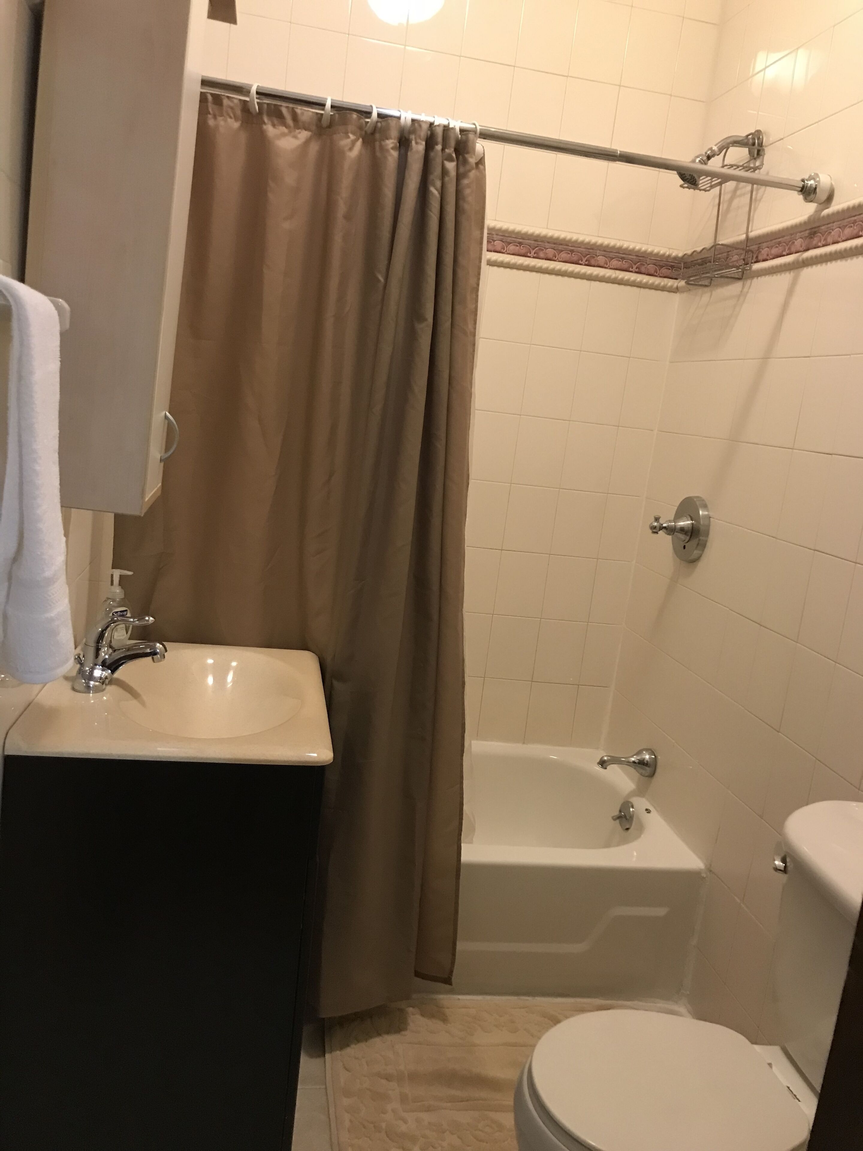 A bathroom with a sink, toilet, and bathtub.