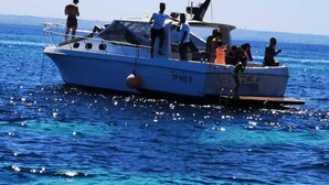 A small boat with people on board, floating on a body of water. - Egadi Islands Boat Excursions (Trapani)