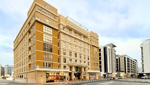 A multi-story ASMA HOTEL with a classic architectural design, featuring a prominent entrance and balconies. -  Asma Hotel (Dubai)
