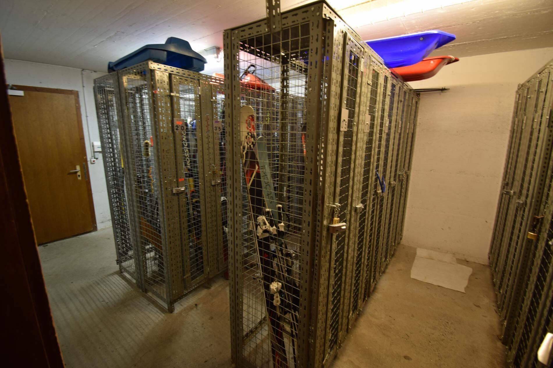 A storage area with metal cabinets, each marked with numbers.