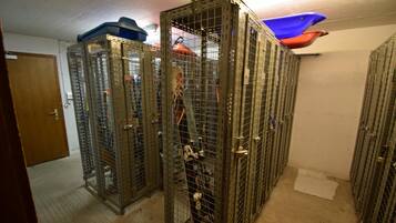 A storage area with metal cabinets, each marked with numbers.