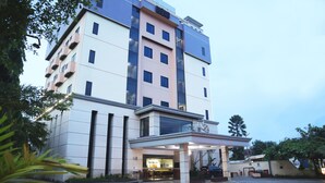 A multi-story hotel with a modern design, featuring a covered entrance and a visible reception area. - Grand Victoria Hotel (Samarinda)