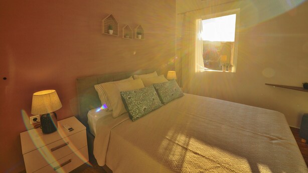 A bedroom with a bed, bedside table, lamp, and decorative wall shelves. - Mpoulakis Apt 46, 3 bedroom family apartment next to my photo studio (Κίσσαμος)