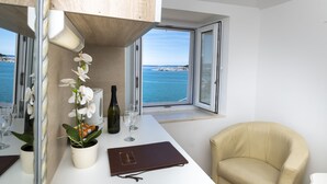 Deluxe Suite, Sea View | Minibar, in-room safe, desk, laptop workspace