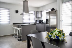 Enjoy cooking in this well-equipped kitchen with a central island, gas stove, and stainless steel appliances.