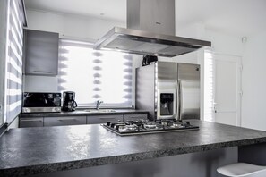 Enjoy cooking in this well-equipped kitchen with a gas stove, microwave, and refrigerator.