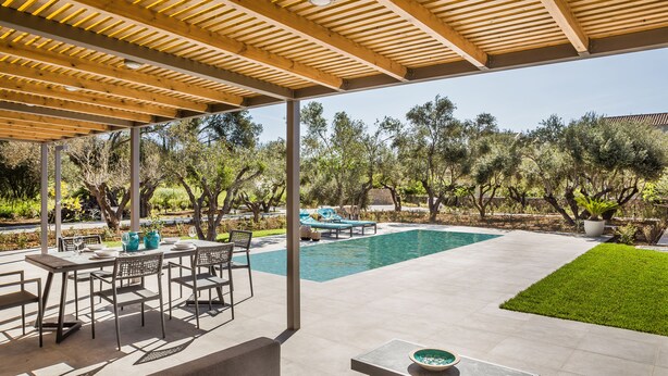 An outdoor patio with a pool, dining area, and covered seating. - VILLA LAURA (Svoronata, Kefalonia)