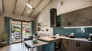 A modern kitchen with a large island, built-in appliances, and a view to the outdoors. - VILLA LAURA (Svoronata, Kefalonia)