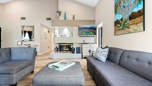 A modern living room with grey sofas, a coffee table, and a TV. - Santa Rosa Cove #6 , 3 bedroom 2 bath Condo! (La Quinta)