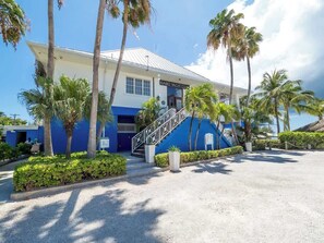 A building with a sign reading "Kaibo Yacht Club" and a staircase leading to the entrance.