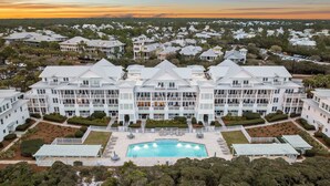 A large, multi-story hotel with a central courtyard and a swimming pool. - Gulf and Pool Views with Beach Access (Santa Rosa Beach)