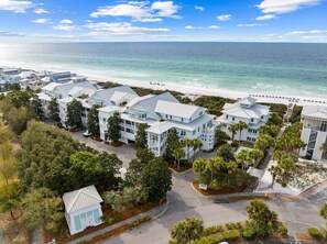 A coastal hotel with multiple-story buildings, a beach view, and a parking area. - Gulf and Pool Views with Beach Access (Santa Rosa Beach)