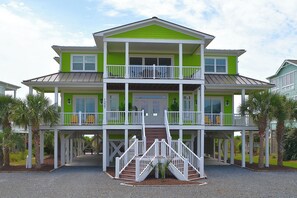 A two-story building with a balcony, a staircase, and a covered walkway. -  OCEAN FRONT HOME w/Heated private Pool, Elevator, 12 Bed/12 Bath, Pet Friendly (Holden Beach)