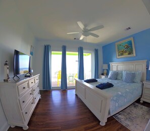 A bedroom with a bed, dresser, ceiling fan, and a painting. -  OCEAN FRONT HOME w/Heated private Pool, Elevator, 12 Bed/12 Bath, Pet Friendly (Holden Beach)