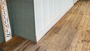 Ein Flur mit Holzboden, weißen Wänden und einem Willkommensschild.
