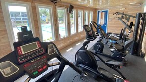 A gym with cardio equipment, a treadmill, and a stationary bike.