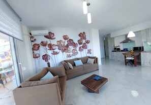 A modern living room with a sofa, coffee table, and decorative wall art. - CIRASOLA HOME (Saranda)
