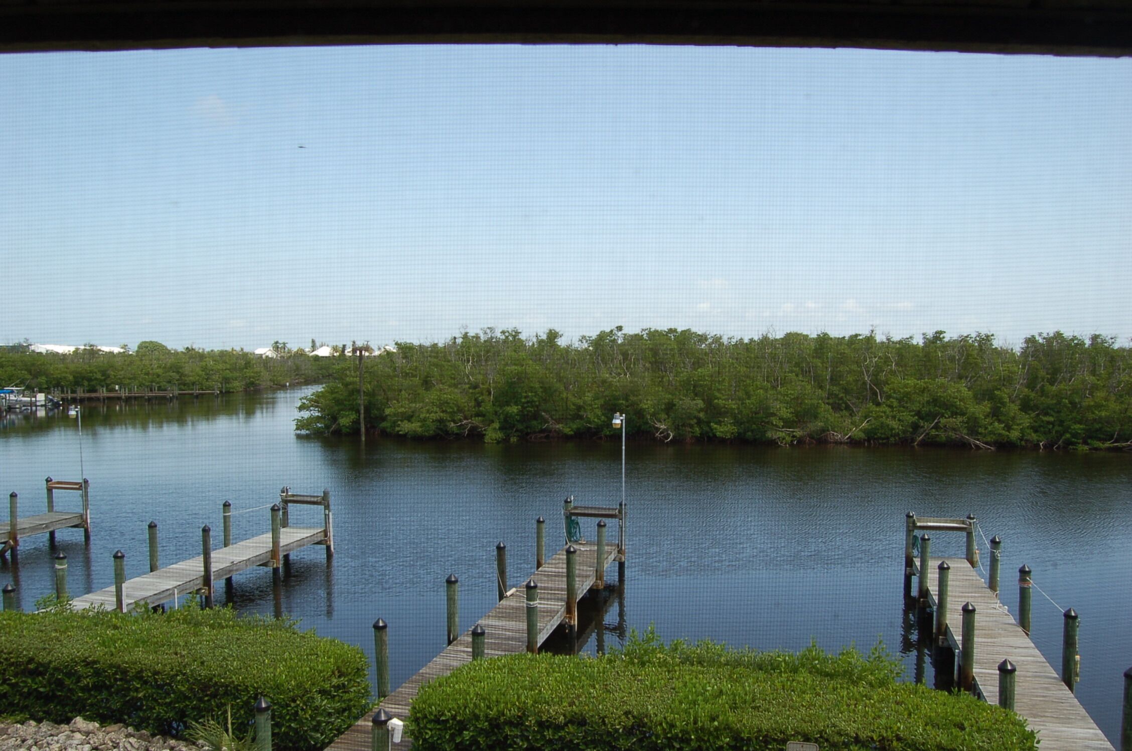 A calm water body with wooden docks extending into it.