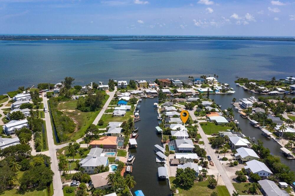 Interested in a 30+ day rental? Please contact the manager for monthly rates.<br><br>This immaculate, newly renovated 2 bedroom, 2 bathroom home is waterfront with direct access to the Intra-coastal Waterway, your gateway to the Gulf of Mexico, Sanibel, Captiva, and Cayo Costa. Bring your boat for some of the most renowned fishing in the country. Upstairs porch overlooking pool and canal. <br><br>**Rents peak season only<br><br>Property Features:<br> • Great dock for fishing<br> • Large lanai with porch overlooking pool & canal<br> • Boat lift, 8,000 lbs.<br> • Screened in lanai balcony<br> • Large pool with screened in lanai<br> • Fully equipped kitchen<br> • Complimentary high speed wireless internet<br><br>Living Area:<br> • Cable TV<br> • DVD Player<br> • Flat screen T.V<br> <br> Laundry Room:<br> • Full size washer and dryer Newly Renovated 2/2 POOL Home with BOAT LIFT, INCREDIBLE ACCESS