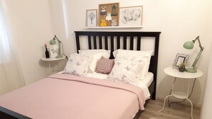 A neatly arranged bedroom with a bed, bedside tables, and wall art. - Apartment in Brela with Seaview, Balcony, Air condition, WIFI (4962-1) (Brela)
