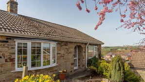 A stone house with a tiled roof, a front door, and a window with a white frame. - Fox Cottage, Middleham, Yorkshire Dales (Middleham)
