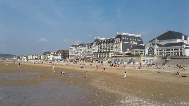 A beach with buildings in the background.