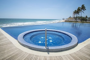 An infinity pool, a heated pool, pool loungers