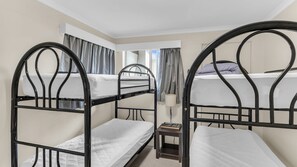 A bunk bed room with a small table and a lamp. - Fishos Hangout 2 - Unit 2 Sinclair St 21 (BERMAGUI)