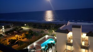 A nighttime view of a coastal hotel with a pool, ocean view, and street lighting. - Oceanfront Condo in Myrtle Beach  (Myrtle Beach)