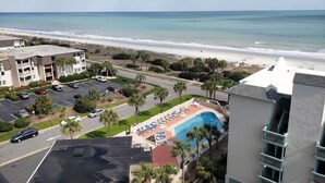 A hotel with a pool, a beach view, and a parking lot. - Oceanfront Condo in Myrtle Beach  (Myrtle Beach)