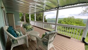 A covered porch with wicker furniture and a view of a lake. - Little Buck Bungalow - Deerfield Lake View Home on Norris Lake (LaFollette)