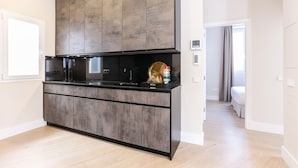 A modern kitchen with a large island, built-in appliances, and a minimalist design.
