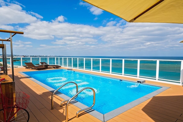 Seasonal outdoor pool, open 10:00 AM to 6:00 PM, pool umbrellas