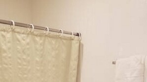 A bathroom with a bathtub, toilet, and a towel rack. - Unity Lodge Suite 3 (Golconda)
