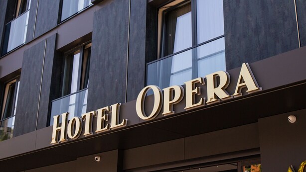 A building with a sign that reads "HOTEL OPERA". - Hotel Opera (Pristina)
