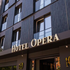 A building with a sign that reads "HOTEL OPERA". - Hotel Opera (Pristina)