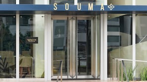 A modern building entrance with a glass door and a sign reading 'SOUMA'. - Souma Hotel, Vignette Collection by IHG (Lima)
